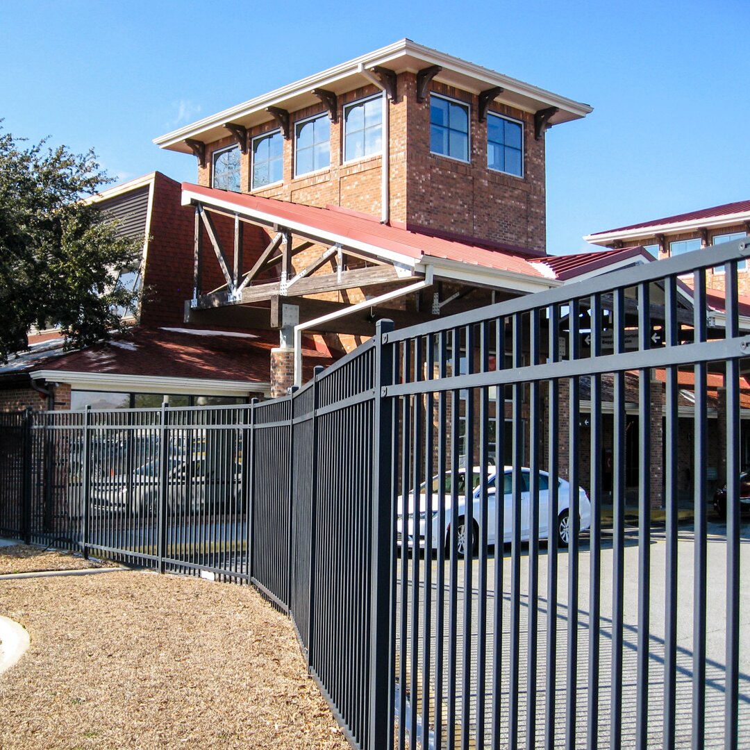 Flat top extruded bottom, three rail panels in front of a business