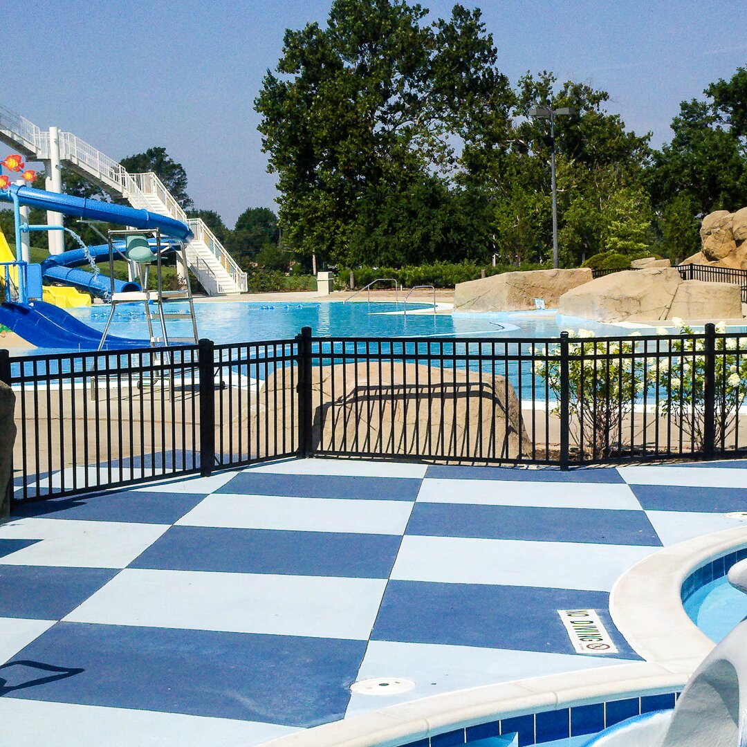 Flat top flat bottom, small fencing surrounding a public pool at a water park