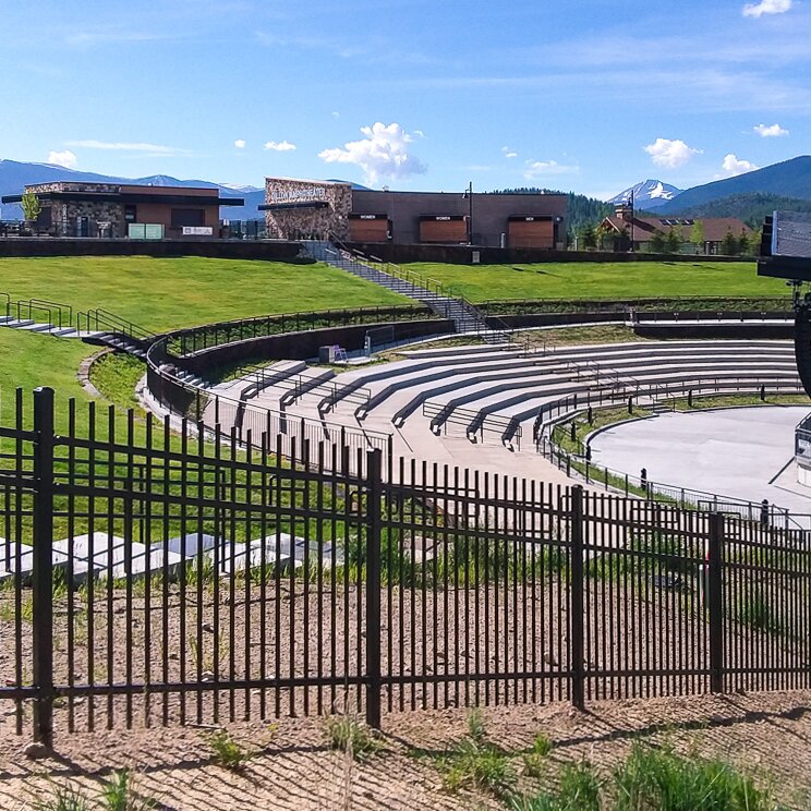Extruded top extruded bottom, three rail fencing at a public music venue