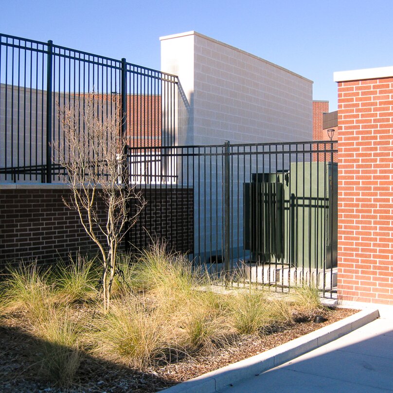 Flat top extruded bottom, three rail fencing surrounding a power unit