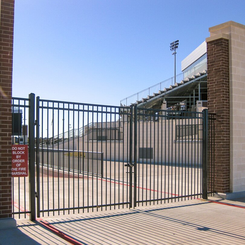 Flat top extruded bottom three rail gates at a sporting venue