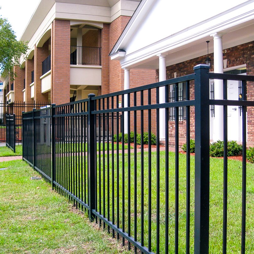 Flat top extruded bottom, three rail, residential fencing, in front of a home