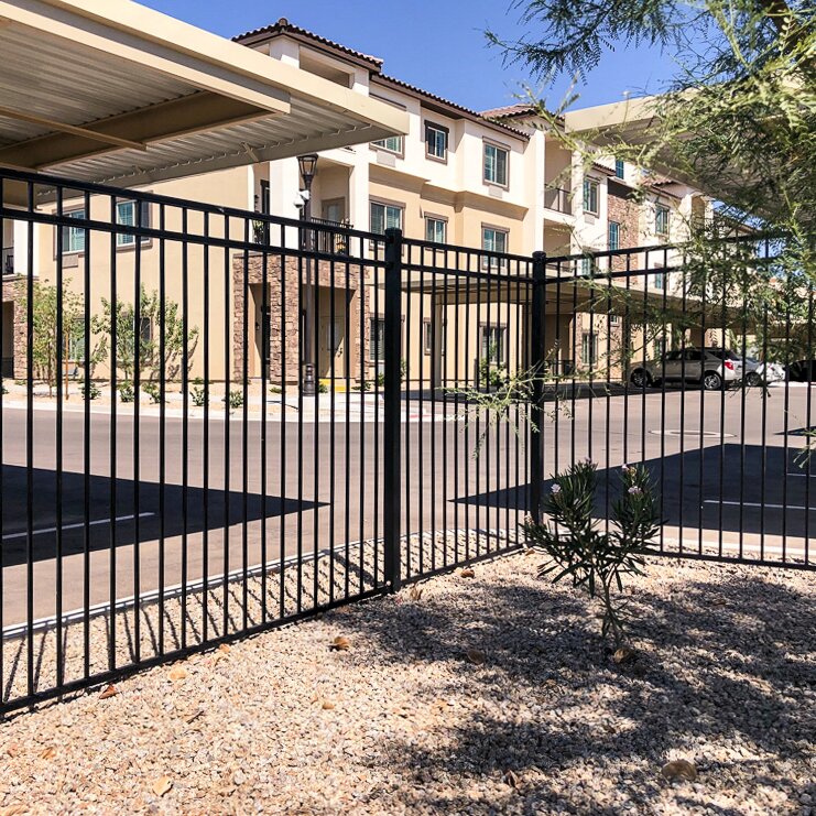 Flat top flat bottom, three rail fencing surrounding in apartment complex and parking lot