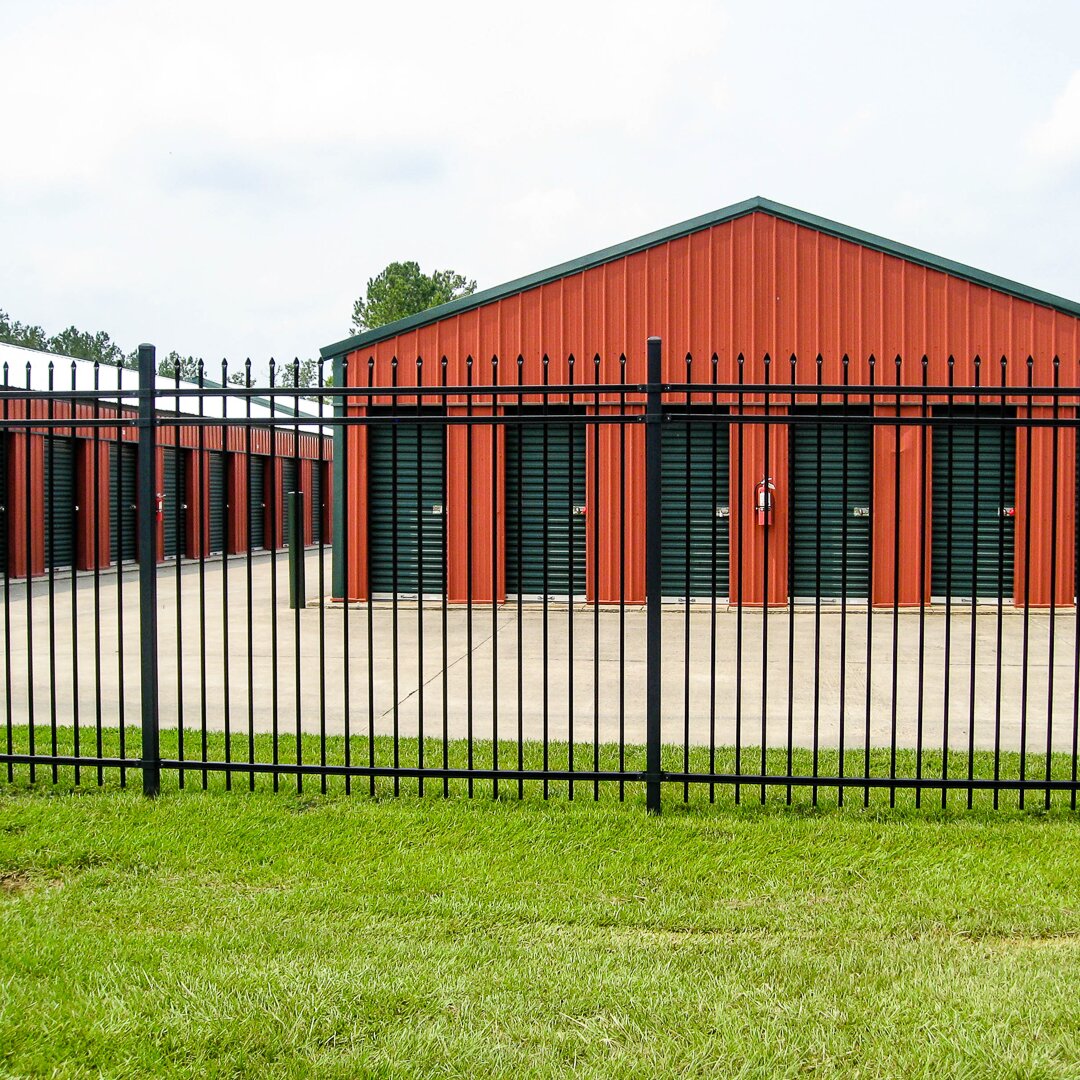 Pressed spear extruded bottom, three rail, fencing, around a temporary storage unit facility