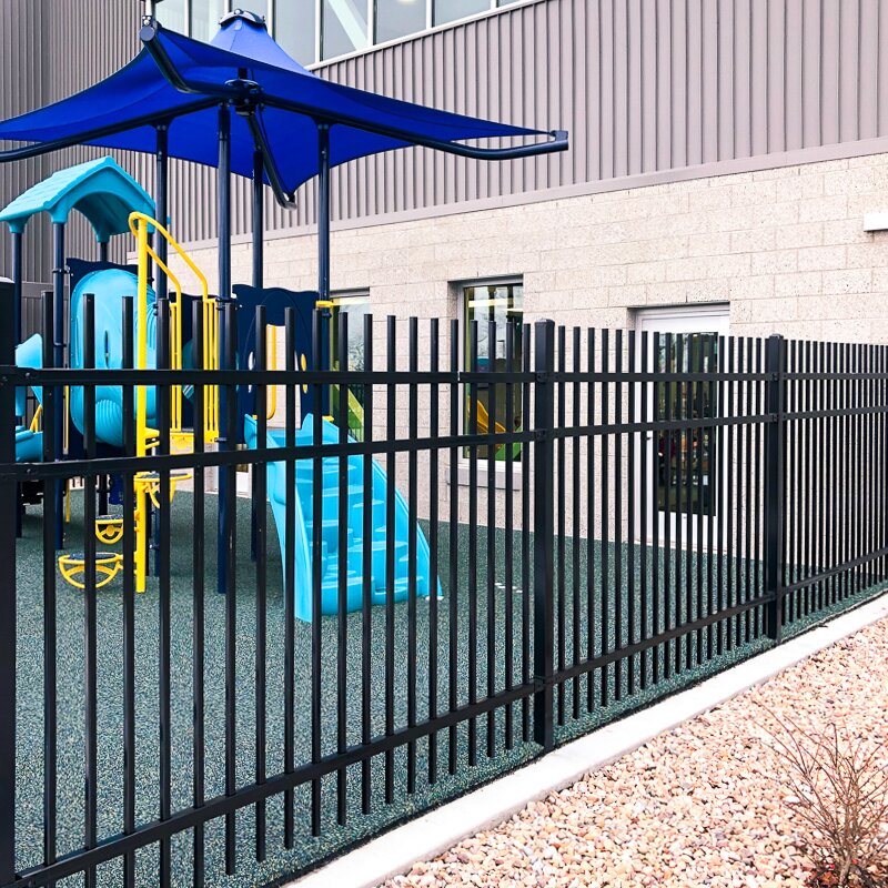 Extruded top extruded bottom, three rail, commercial fencing around a public school playground