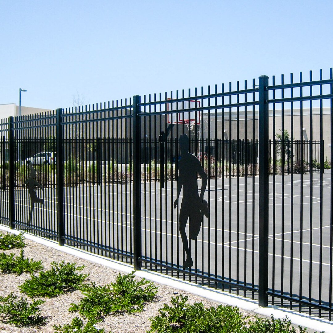 Extruded top extruded bottom, three rail fencing surrounding a basketball court with metal cut outs of sports players on the fencing