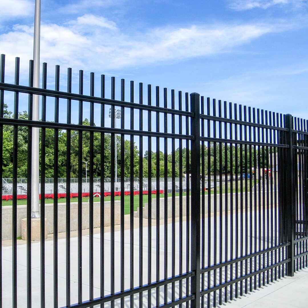 Extruded top extruded bottom, four rail commercial fencing around a school sports field