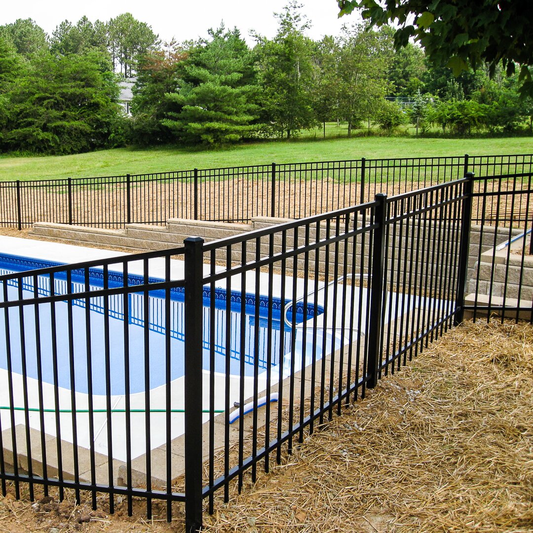 Flat top extruded bottom, three rail fencing surrounding a pool