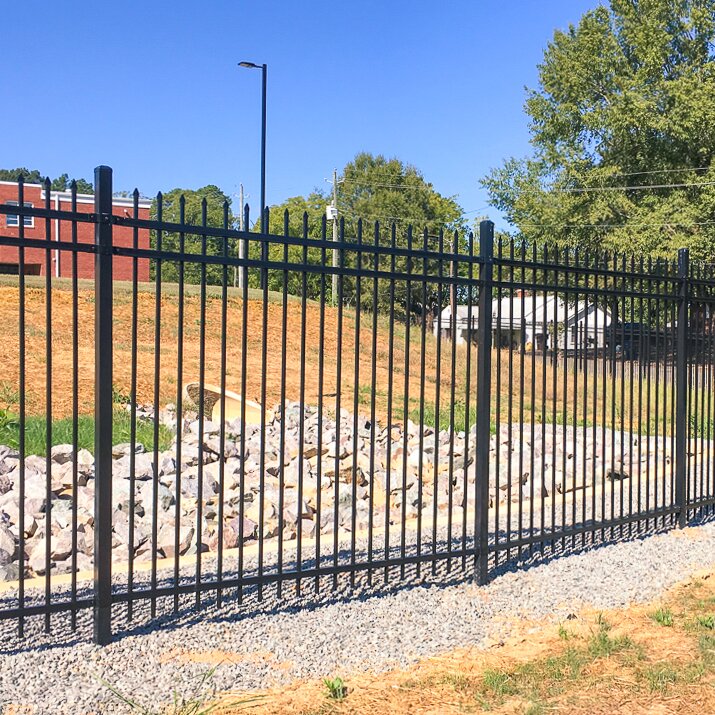 Pressed spear extruded bottom, three rail fencing surrounding a water outlet