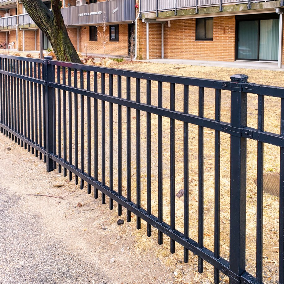 Flat top extruded bottom, three rail panels in front of an apartment